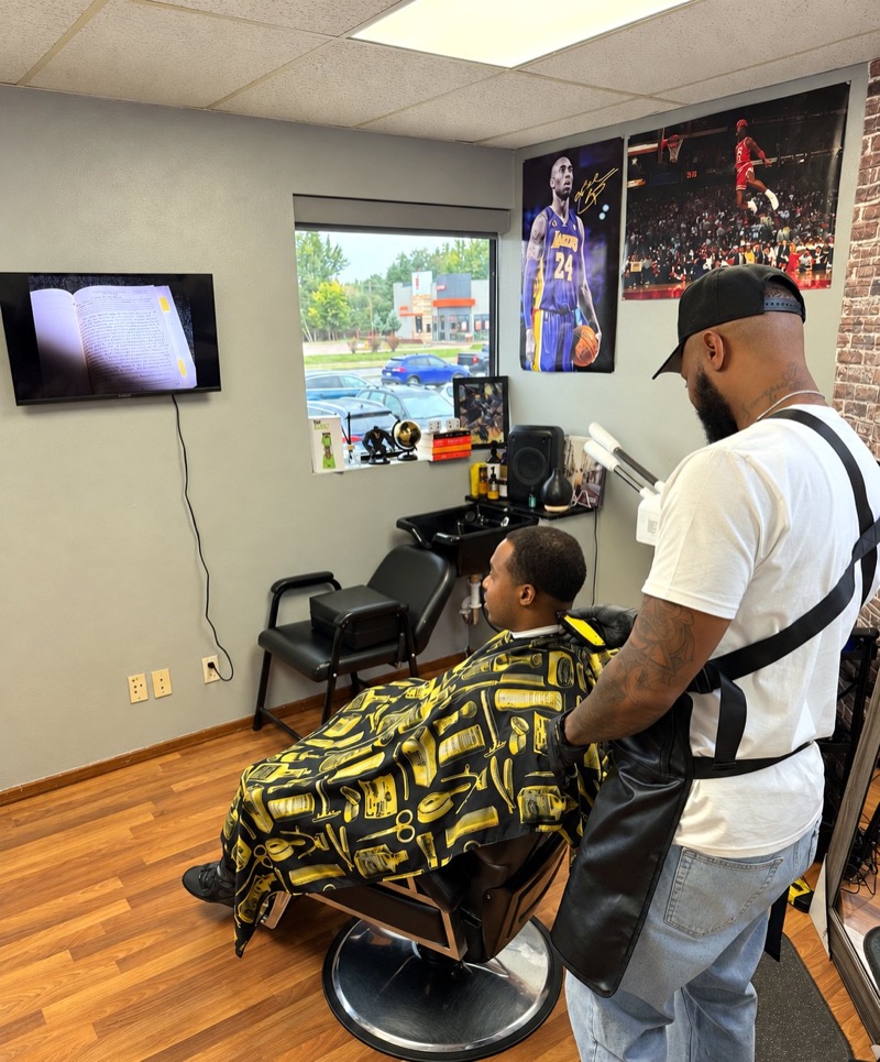Barber giving a client a haircut in his own suite at Springs Spa & Salon in Colorado Springs